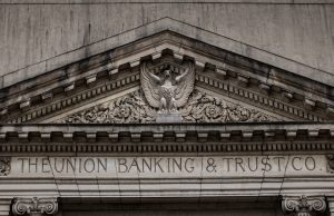 S&P Projects 5-6% Loan Growth for Malaysian Banks S&P Global Ratings logo on a building facade in Kuala Lumpur, with Malaysian bank skyscrapers in the background.