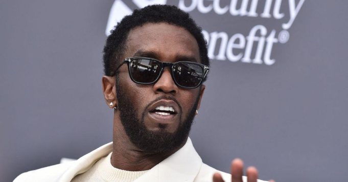 Sean Combs 2024 Red Carpet Sean Combs standing on stage with a microphone, performing at a music event.