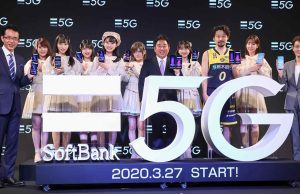 SoftBank store front in Tokyo with 5G banner and customers testing new phones on launch day