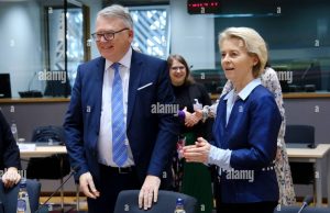EU Leaders Face Subsidy Rift Before US Summit European Union leaders seated at a summit table in Brussels, with documents and flags visible, highlighting internal divisions over subsidy policies.