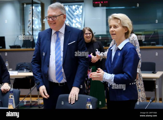 Ursula Von Der Leyen Brussels Summit European Union leaders seated at a summit table in Brussels, with documents and flags visible, highlighting internal divisions over subsidy policies.