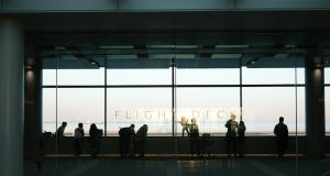 Philippines Repatriates 314 Tourists to Wuhan Chinese tourists boarding a repatriation flight at a Philippine airport amid health screening protocols.