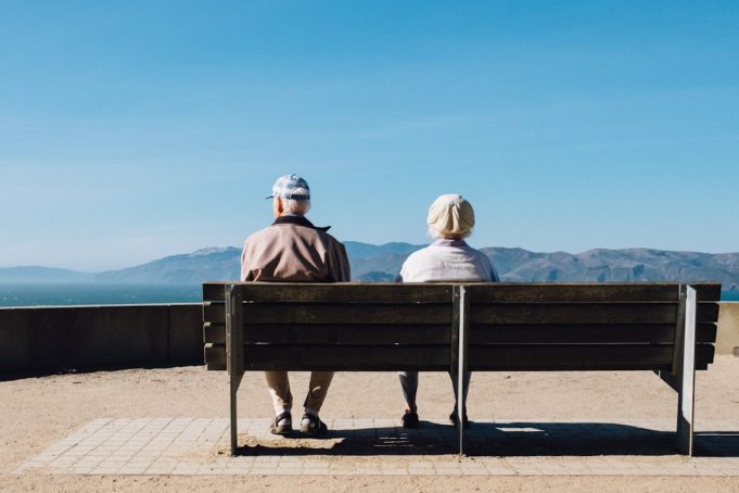FDA Approves Donanemab for Early Alzheimer's, Citing 36.8% Brain Swelling Risk A doctor reviewing brain scan images on a monitor while an elderly patient sits nearby in a clinic examining room.