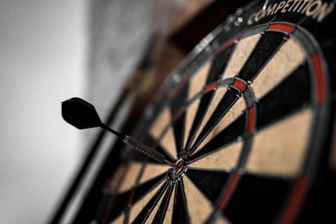 Prostate Cancer UK Set for Record Donation from Darts 180s Darts players throw at a board at Alexandra Palace as a 180 lights up the scoreboard for Prostate Cancer UK
