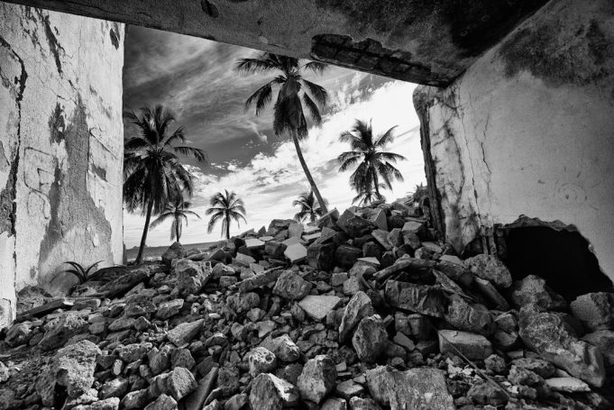Cracked concrete walls and debris fill a narrow street in Myitkyina after the 5.9 quake shook Kachin State.