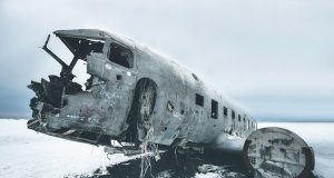 Beechcraft King Air B200 Crash Kills 4 at Southend Airport Fire crews spray foam on a burning twin-turboprop aircraft beside the Southend runway at dusk.